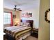 Bedroom with striped bedding, bedside table, and a window with curtains at 6358 Granger Rd, Port Charlotte, FL 33981