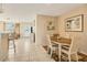 Charming dining area with wood table and four chairs, adjacent to the kitchen at 6358 Granger Rd, Port Charlotte, FL 33981