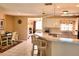 Bright kitchen with breakfast bar seating, granite countertops, and modern appliances at 6358 Granger Rd, Port Charlotte, FL 33981