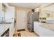 Kitchen featuring white cabinets, stainless steel appliances, and tiled floor at 6358 Granger Rd, Port Charlotte, FL 33981
