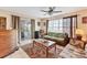 Relaxing living room with a view to the lanai, featuring comfortable seating and natural light at 6358 Granger Rd, Port Charlotte, FL 33981
