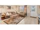 Inviting living room with neutral tones, a palm tree rug, and ample natural light at 6358 Granger Rd, Port Charlotte, FL 33981