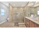 Modern bathroom with walk-in shower and pebble floor at 6571 Talon Bay Dr, North Port, FL 34287