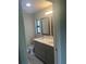 Bathroom with gray double vanity, two mirrors and light gray flooring at 7320 Freeberg Cir, Port Charlotte, FL 33981