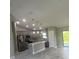 Open concept kitchen with island, stainless steel appliances, and gray cabinets at 7320 Freeberg Cir, Port Charlotte, FL 33981