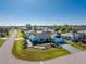 Aerial view of a teal home with a landscaped yard and driveway at 9457 Heartwellville Ave, Englewood, FL 34224