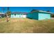 Large backyard with grass, detached garage, and a clothesline at 9457 Heartwellville Ave, Englewood, FL 34224