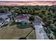 Aerial view of a single-story home with a large yard at sunset at 9487 Prospect Ave, Englewood, FL 34224