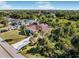 Aerial view of single-story home with large yard, driveway, and tropical landscaping at 9487 Prospect Ave, Englewood, FL 34224