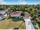 Single-story home with a large yard, driveway and lush landscaping in a quiet neighborhood at 9487 Prospect Ave, Englewood, FL 34224