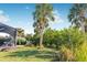 Landscaped backyard with lush tropical plants and palm trees at 9487 Prospect Ave, Englewood, FL 34224