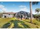 View of the home from the backyard, highlighting the screened pool area at 9487 Prospect Ave, Englewood, FL 34224