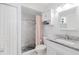 Clean bathroom with granite countertop, white cabinets, and a walk-in shower at 9487 Prospect Ave, Englewood, FL 34224