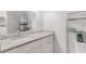 Bathroom with granite countertop, white cabinets, and shower/tub combo at 9487 Prospect Ave, Englewood, FL 34224