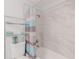 Bathroom with shower/tub combo, grey tile, and a blue and grey striped curtain at 9487 Prospect Ave, Englewood, FL 34224