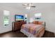 Bedroom with a full-size bed, dresser, and large windows at 9487 Prospect Ave, Englewood, FL 34224