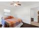 Bedroom with a full-size bed, dresser, and access to a bathroom at 9487 Prospect Ave, Englewood, FL 34224
