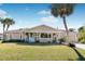 Charming single-story home with a covered porch and landscaped lawn at 9487 Prospect Ave, Englewood, FL 34224