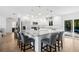 Modern kitchen featuring white cabinetry, granite island, and stainless steel appliances at 9487 Prospect Ave, Englewood, FL 34224