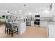 Modern kitchen with white cabinets, granite countertops, and a large island at 9487 Prospect Ave, Englewood, FL 34224