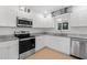 Modern kitchen with stainless steel appliances and granite countertops at 9487 Prospect Ave, Englewood, FL 34224
