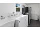 Laundry room with washer, dryer, and utility sink at 9487 Prospect Ave, Englewood, FL 34224