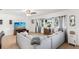 Spacious living room with gray sectional sofa and bay window at 9487 Prospect Ave, Englewood, FL 34224