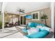 Covered patio area with comfortable seating overlooking the pool at 9487 Prospect Ave, Englewood, FL 34224