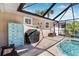 Enjoy this relaxing pool area, complete with a screened enclosure and patio furniture at 9487 Prospect Ave, Englewood, FL 34224