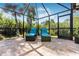 Spacious screened patio with comfortable lounge chairs, perfect for relaxing at 9487 Prospect Ave, Englewood, FL 34224