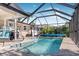 Enjoy this refreshing pool with a screened enclosure and patio at 9487 Prospect Ave, Englewood, FL 34224