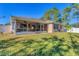 Screened patio with ceiling fan overlooking grassy backyard at 3258 N Biscayne Dr, North Port, FL 34291