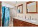 Bathroom with double vanity, granite countertop, and shower at 3258 N Biscayne Dr, North Port, FL 34291