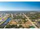 Aerial view of a residential neighborhood with a canal and ocean views at 109 Bonita Dr, Rotonda West, FL 33947