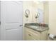 Clean bathroom with granite countertop, double sinks, and large mirror at 109 Bonita Dr, Rotonda West, FL 33947