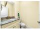 Small bathroom with granite countertop, single sink, and toilet at 109 Bonita Dr, Rotonda West, FL 33947