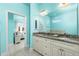 Bathroom with double vanity, granite countertop, and a view of a bedroom at 109 Bonita Dr, Rotonda West, FL 33947