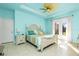 Main bedroom with a king-size bed, access to the backyard and light blue walls at 109 Bonita Dr, Rotonda West, FL 33947