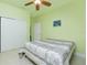 Bedroom with a queen bed, ceiling fan, double doors, and light green walls at 109 Bonita Dr, Rotonda West, FL 33947
