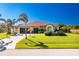 Single-story home with a three-car garage and lush landscaping at 109 Bonita Dr, Rotonda West, FL 33947