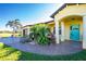Front view of house, teal door, and landscaped entryway at 109 Bonita Dr, Rotonda West, FL 33947