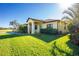 House exterior with teal front door and manicured lawn at 109 Bonita Dr, Rotonda West, FL 33947