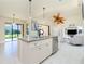 Spacious kitchen with island, granite countertops, stainless steel appliances, and view to backyard at 109 Bonita Dr, Rotonda West, FL 33947