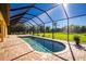 Screened pool and patio area with backyard view at 109 Bonita Dr, Rotonda West, FL 33947