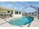 Enjoy this screened-in kidney shaped pool with plenty of lounging space at 1113 Brown St, Englewood, FL 34224