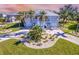 Stunning two-story home with circular driveway and manicured landscaping at 13104 Via Cassia, Placida, FL 33946