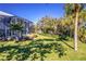 Spacious backyard with a pool, lush landscaping, and palm trees at 13104 Via Cassia, Placida, FL 33946