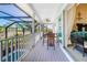 Covered balcony with outdoor seating and pool views at 13104 Via Cassia, Placida, FL 33946