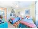 Twin bedroom with colorful decor and access to a hallway at 13104 Via Cassia, Placida, FL 33946