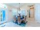 Bright dining room with a round table, wicker chairs, and light wood floors at 13104 Via Cassia, Placida, FL 33946